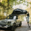 Man climbing into the Voyage L family roof tent